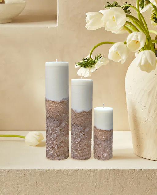 Three Rose Quartz Crystal Candles Displayed on a Beige Shelf with Flowers Showing How to use It In Home Decor